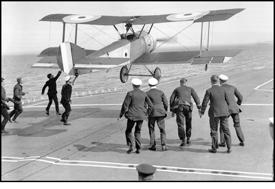 Squadron Commander Edwin Dunning landing an aircraft on the deck of a moving ship.