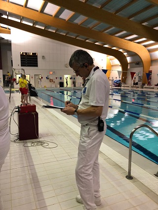 Derek Allan recording times at the poolside.