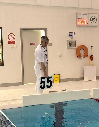 Derek Allan checking swimmers at the poolside.