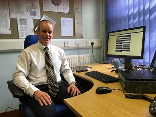 Andrew Hamilton at his desk.