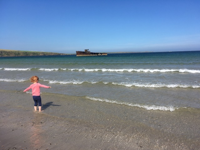 Child enjoying a beach trip at Inganess, Orkney