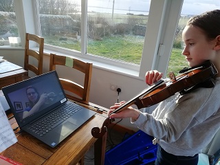 Lynn teaching a pupil by video call.