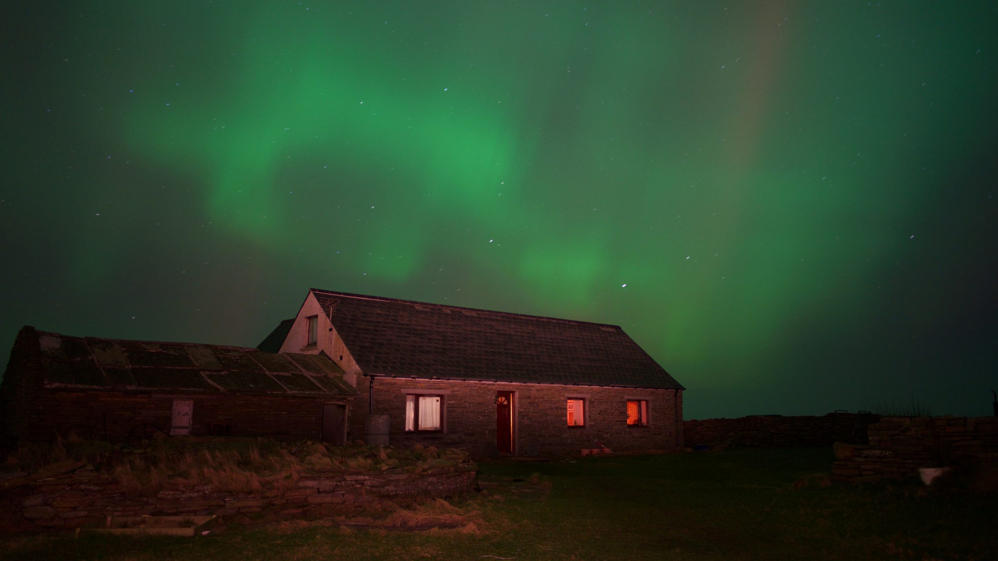 A photo of the Sanger croft house, North Ronaldsay, Orkney, with a backdrop of Aurora Borealisv by Peter Donnelly.