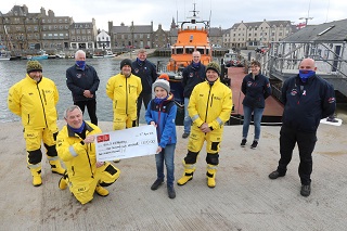 Murray Budge hands over the cheque to Stewart Ryrie of Kirkwall Lifeboat. From the left are: Ingram Dearness, Stewart, Mike Cooper, Paul Turner, Davie Flett, Murray, Aly Drever, Graham Campbell, Kate Irvine Lewis and John Tulloch.