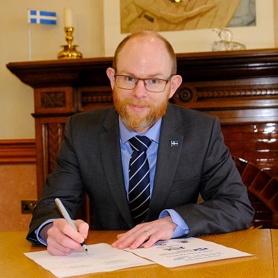 Councillor Steven Coutts, Leader of Shetland Islands Council - signing.