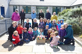 Nursery pupils with members of the SWI.