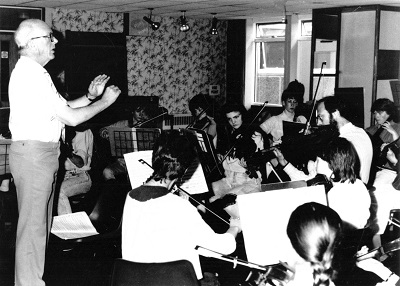 Music: conducting a class of pupils.