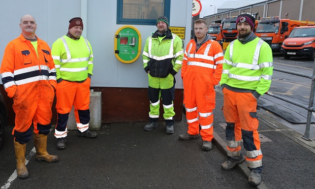 A new defibrillator has been installed at Orkney Islands Council’s Roads services depot in Hatston – and the team is keen the wider community knows it is there for anyone to use in an emergency - photo of Roads services team members beside the new defib.