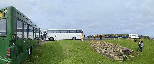 An image of the car park at Birsay busy with cars, buses, campervans and visitors.