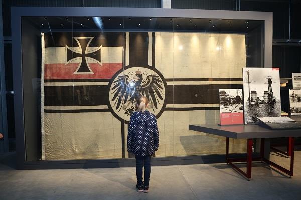 Image of child viewing the German Ensign on display at Scapa Flow Museum