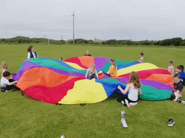 children playing with a parachute