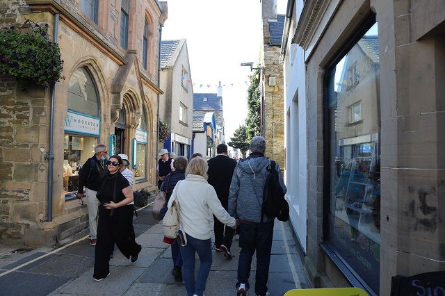 people walking down a local high street