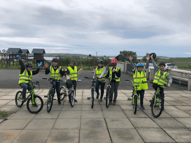 7 children in hi-vis riding their bikes