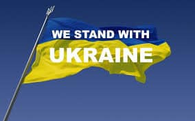 we stand with Ukraine poster with flag in background