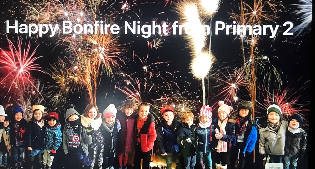 kids standing in front of a fireworks display