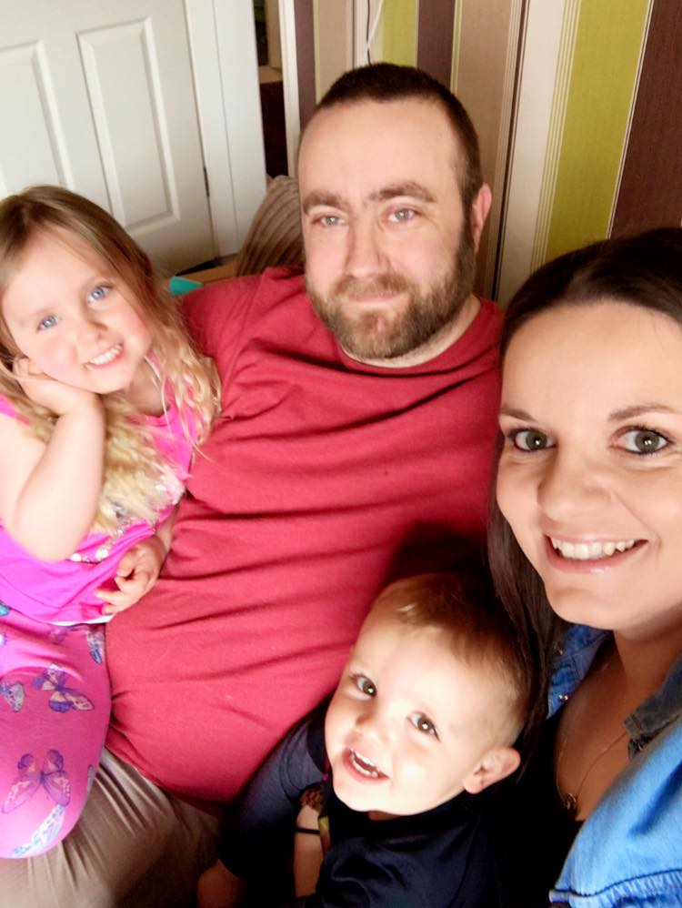 a man, lady, young girl and young boy, family photo