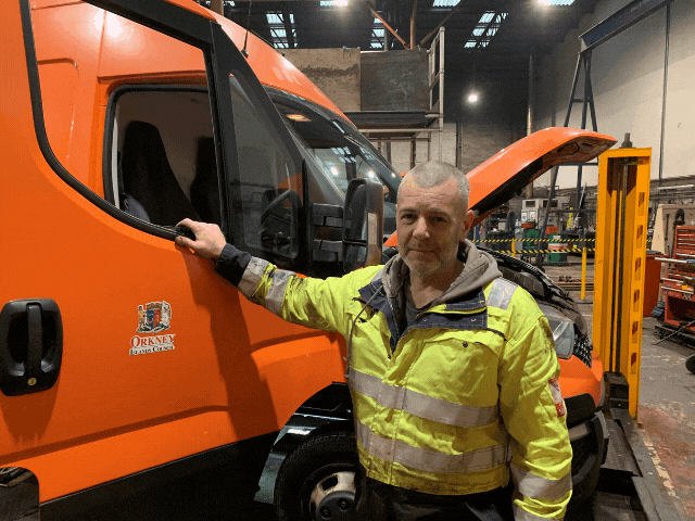 a man working, getting into a van