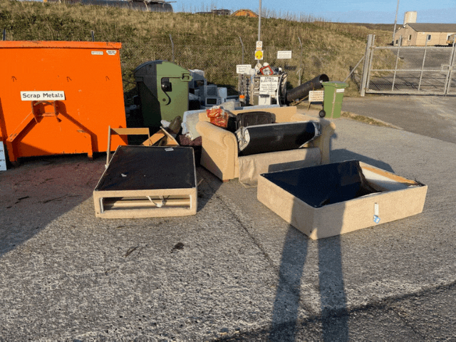 3 wooden boxes with black soil in them