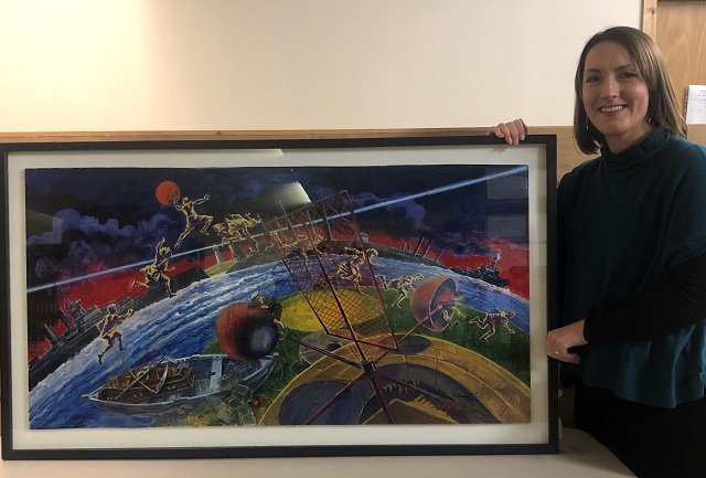 A lady standing by a painting
