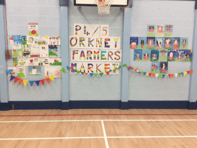a school hall with bunting and banners up saying p4/5 Orkney farmers marker