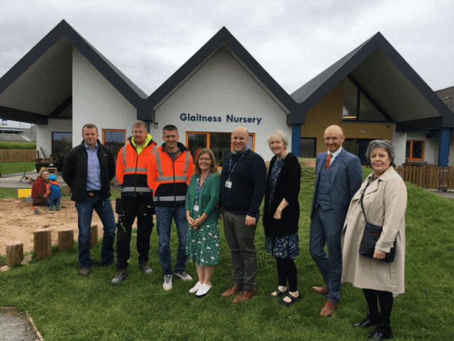8 people standing in front of a school extension