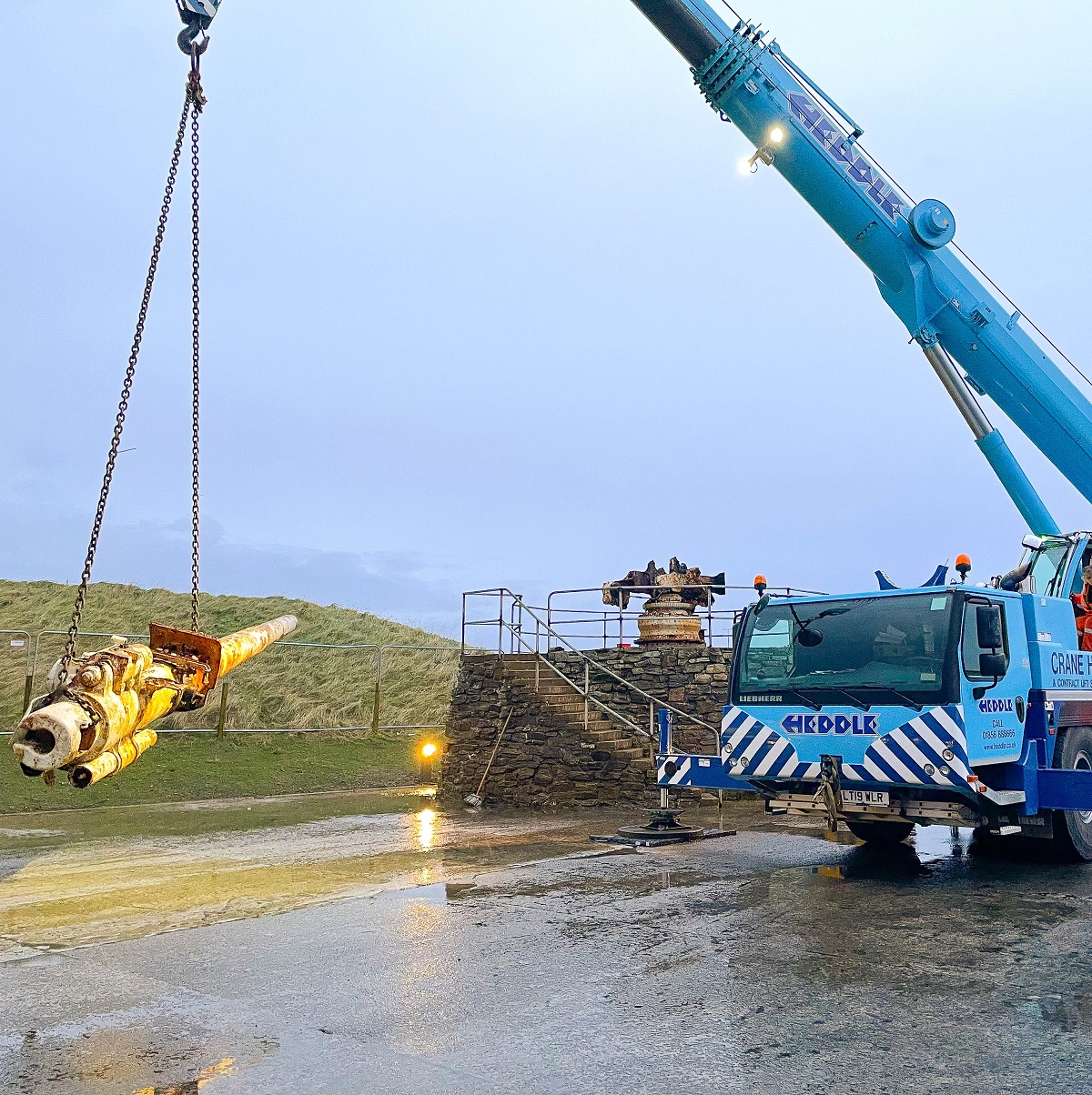 Crane lifting a gun barrell