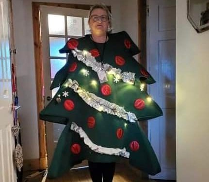 A lady dressed up as Christmas tree