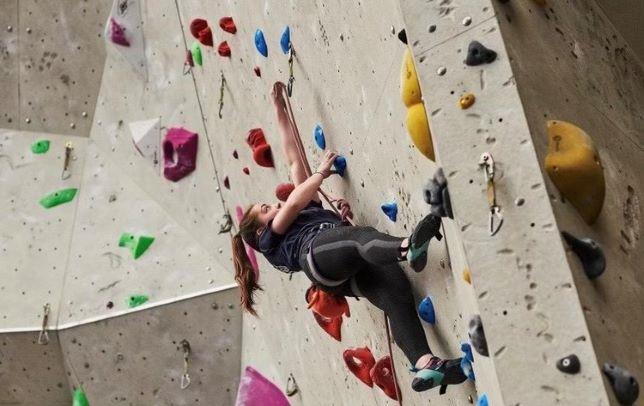 A young girl on a climbing wall