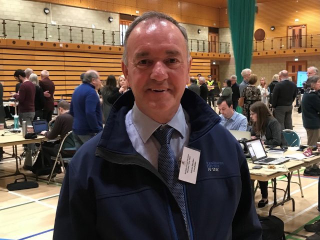 a man standing smiling at the camera at the elections