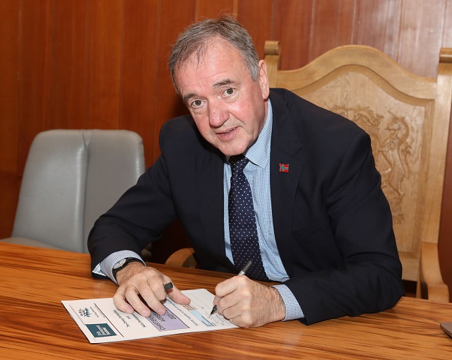 A man signing a document