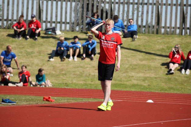 a young boy about to throw a javelin