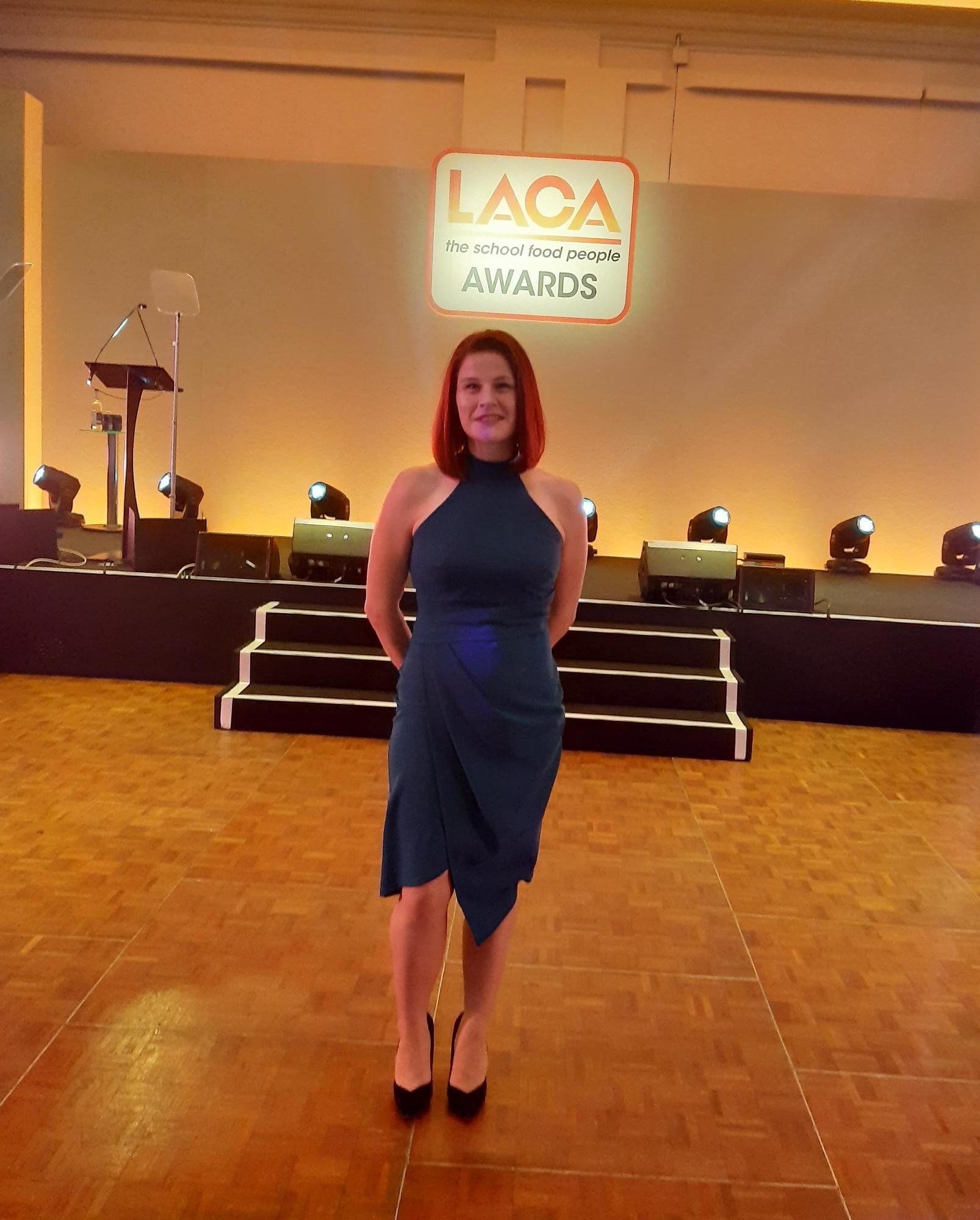 a woman standing at an awards show