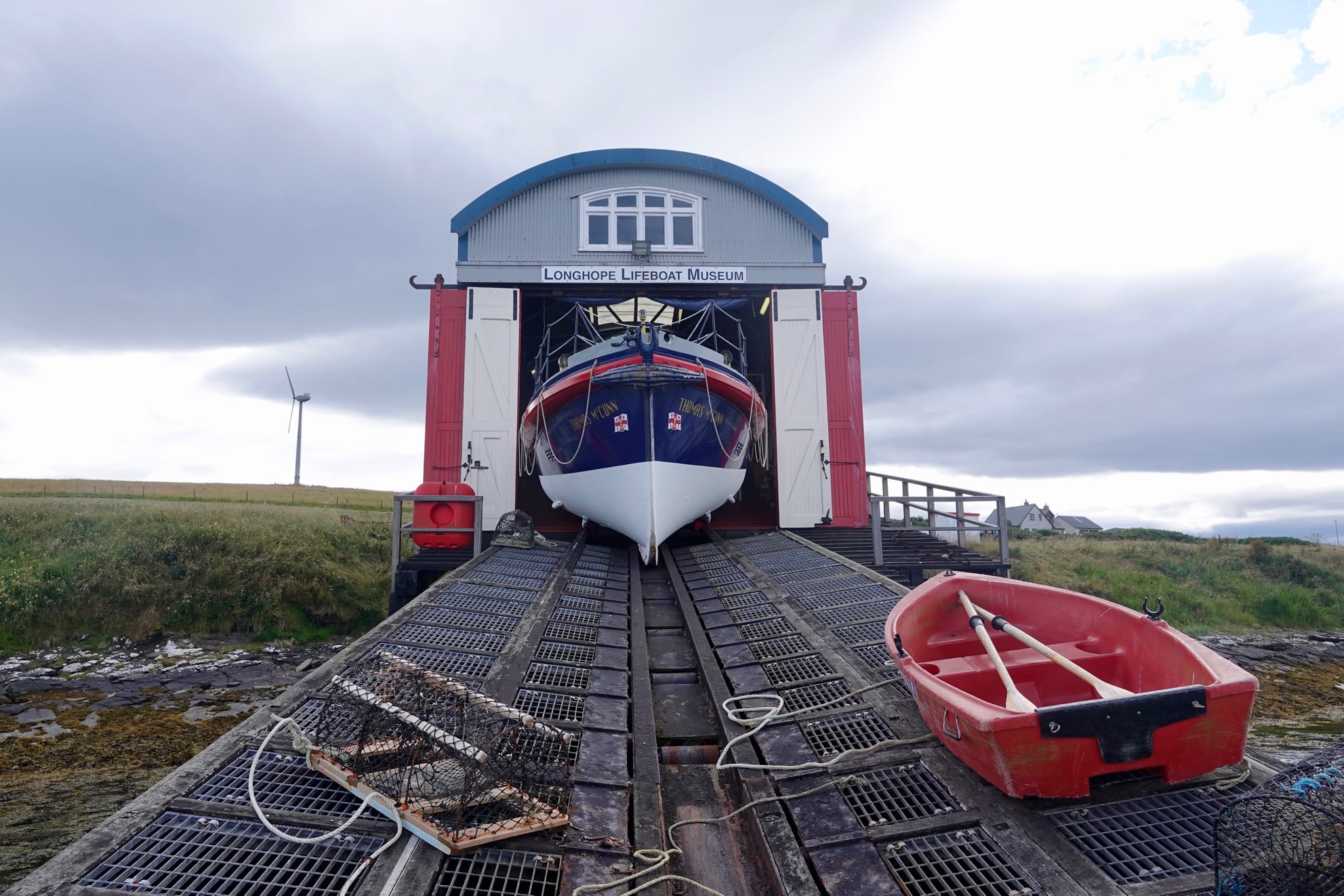 a lifeboat coming out of a shed sliding down rails