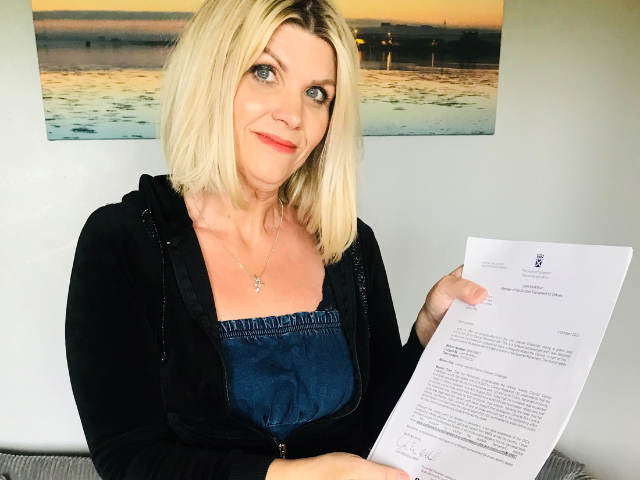 a lady holding a letter