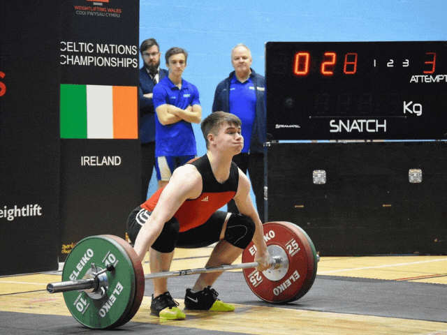 a male attempting to weightlift