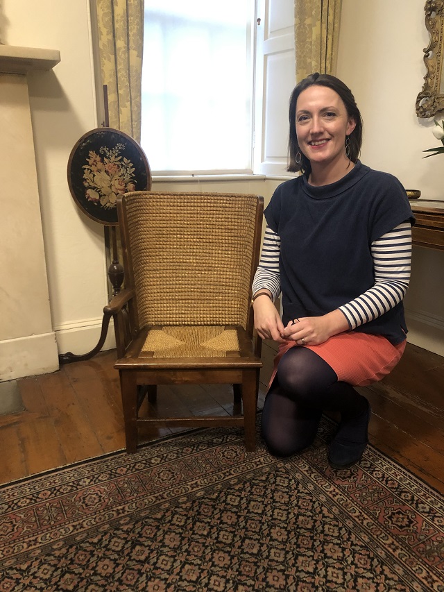 a lady sitting beside an Orkney chair