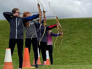 4 children plauying archery
