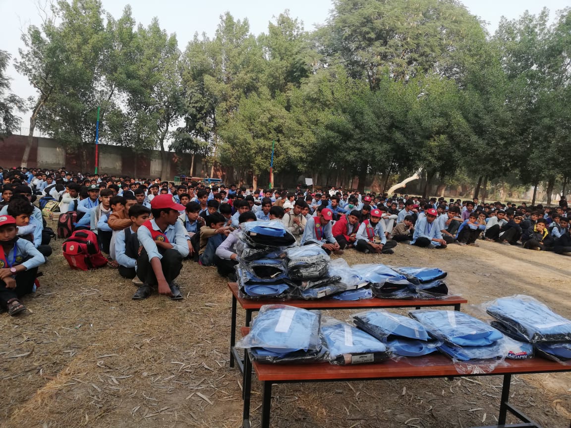 Children lined up awaiting school uniform