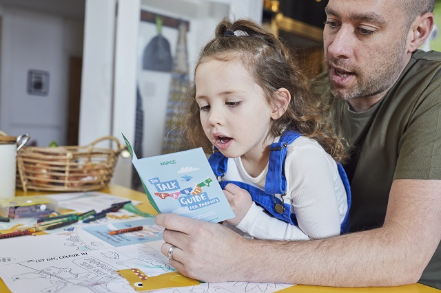 a man reading a child a story