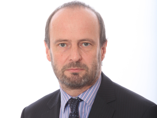 a passport photo of a man in a suit