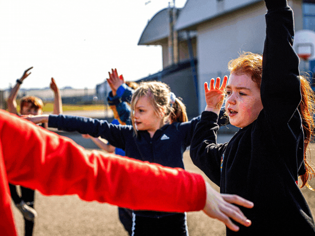children dancing in a playground
