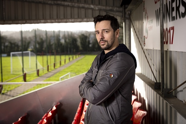 a man standing in a football stand