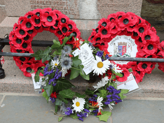 Rememberance day, red poppy heart with flowers in front