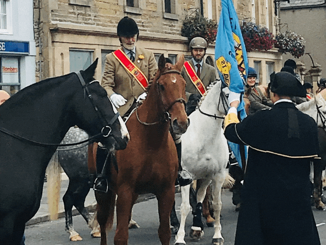 2 people on horses during a march