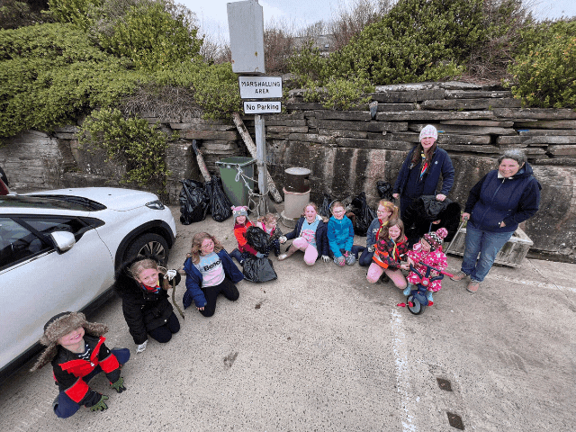 children sat smiling at camera