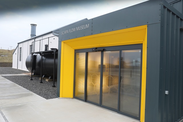 Scapa Flow Museum - a grey building with a yellow doorway