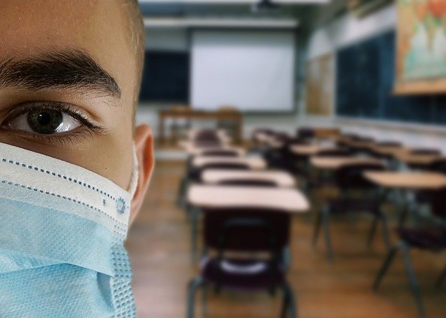 a boy with only one eye visible on the picture with a mask on