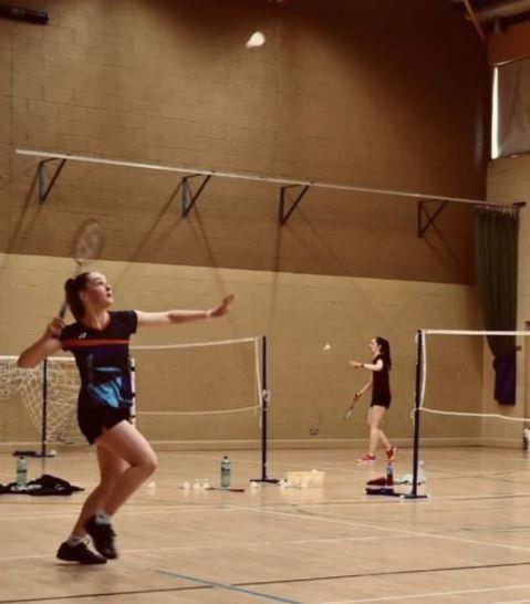 2 people playing badminton