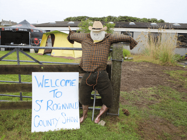 sign and scarecrow saying welcome to St Rognvald County Show