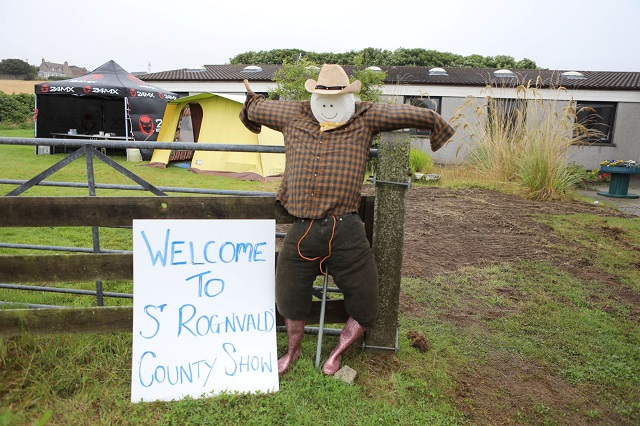 a scarecrow and a sign saying welcome to St Rognvald County Show